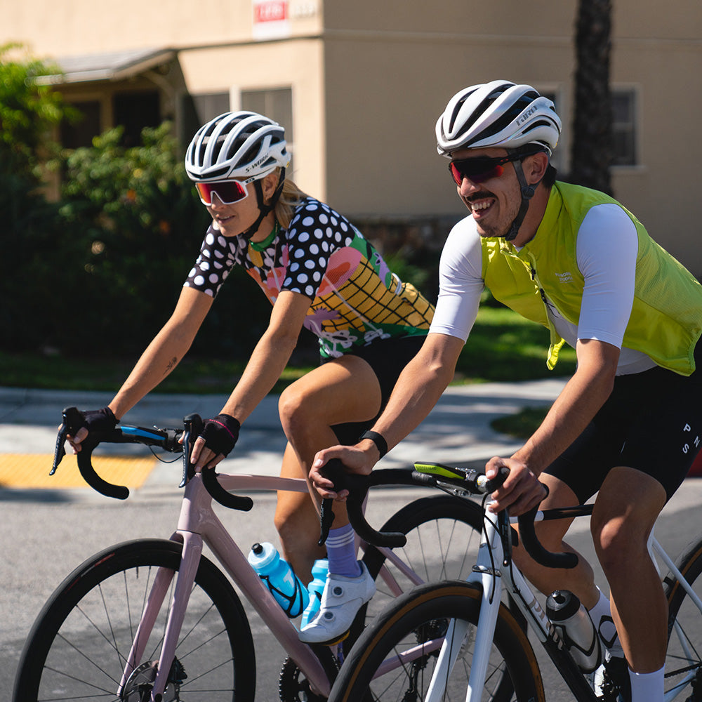 A male and female cyclist, both riding with Karoo 2 Custom Color Kits.